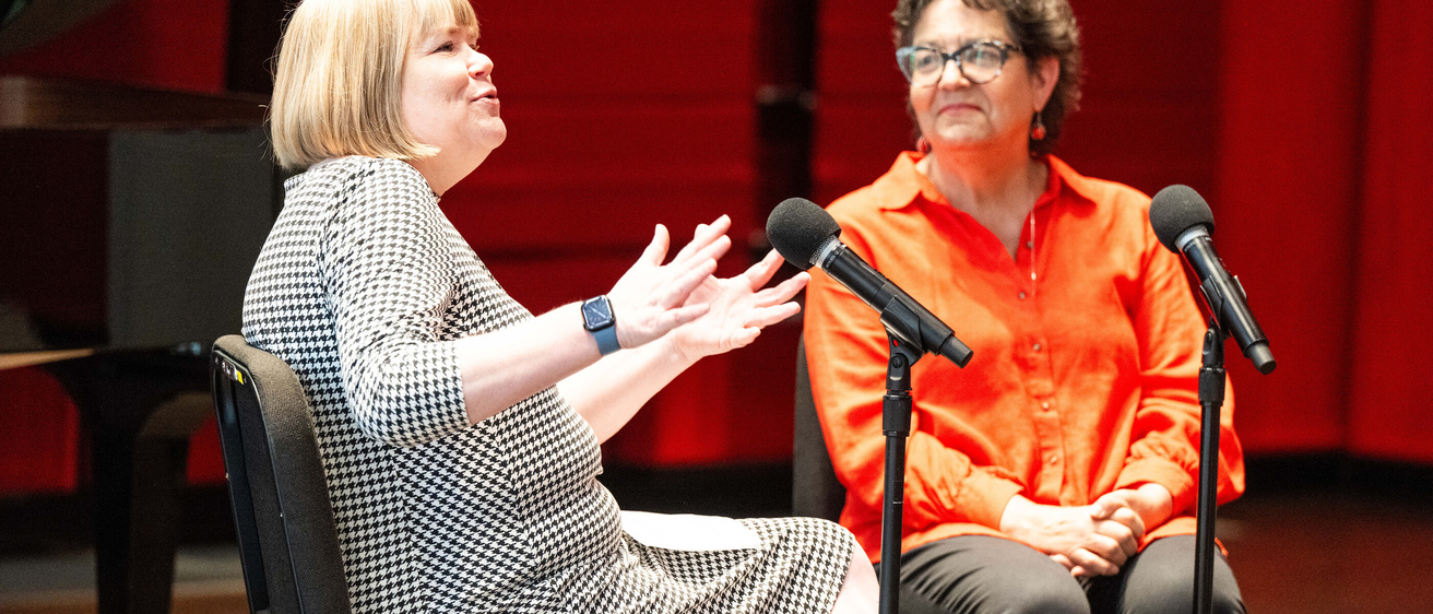 Mercedes Bern-Klug (School of Social Work, CLAS) and Amy Colbert (Tippie College of Business) talking on stage